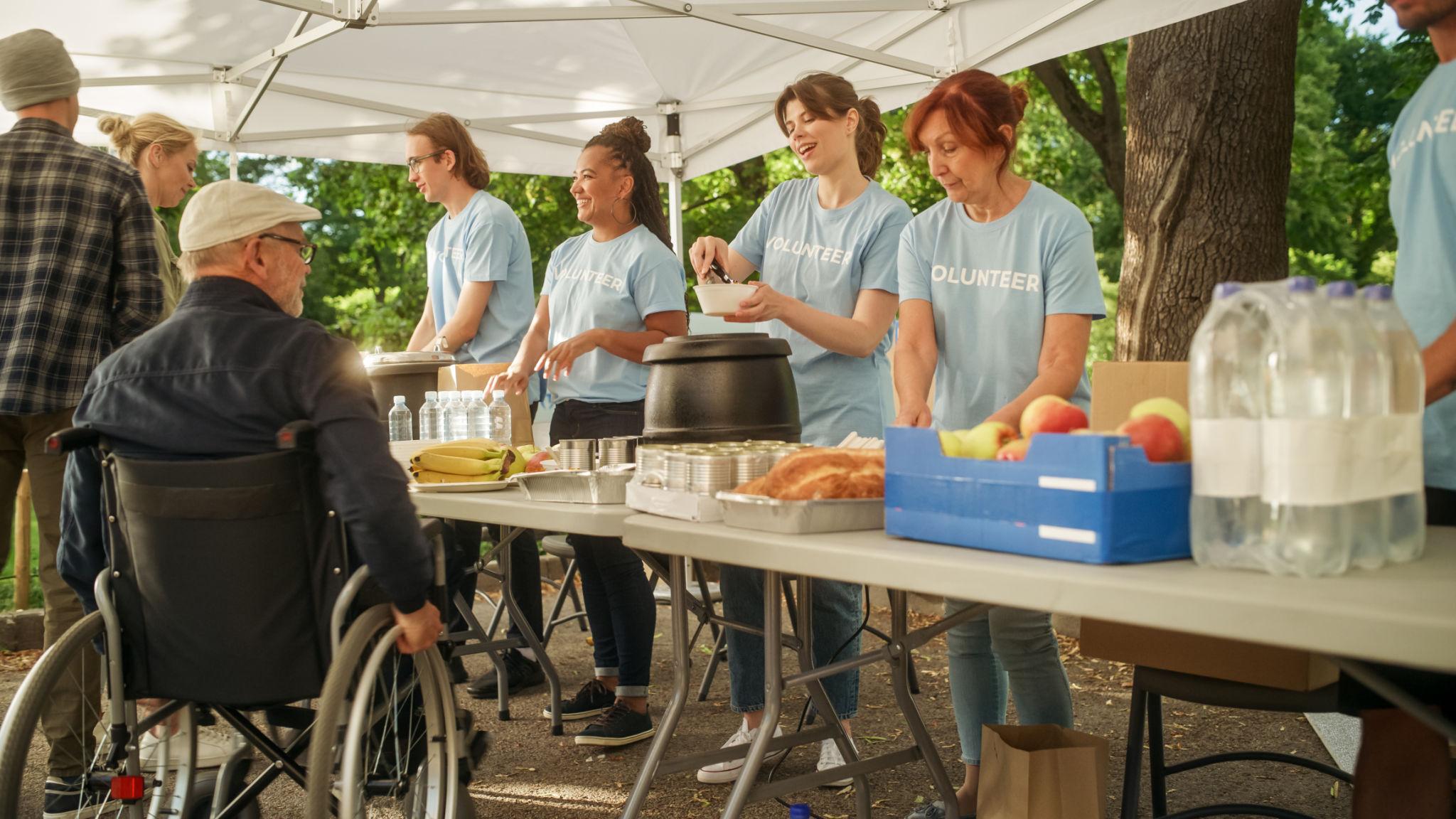 Volunteers serving food together at a community event
